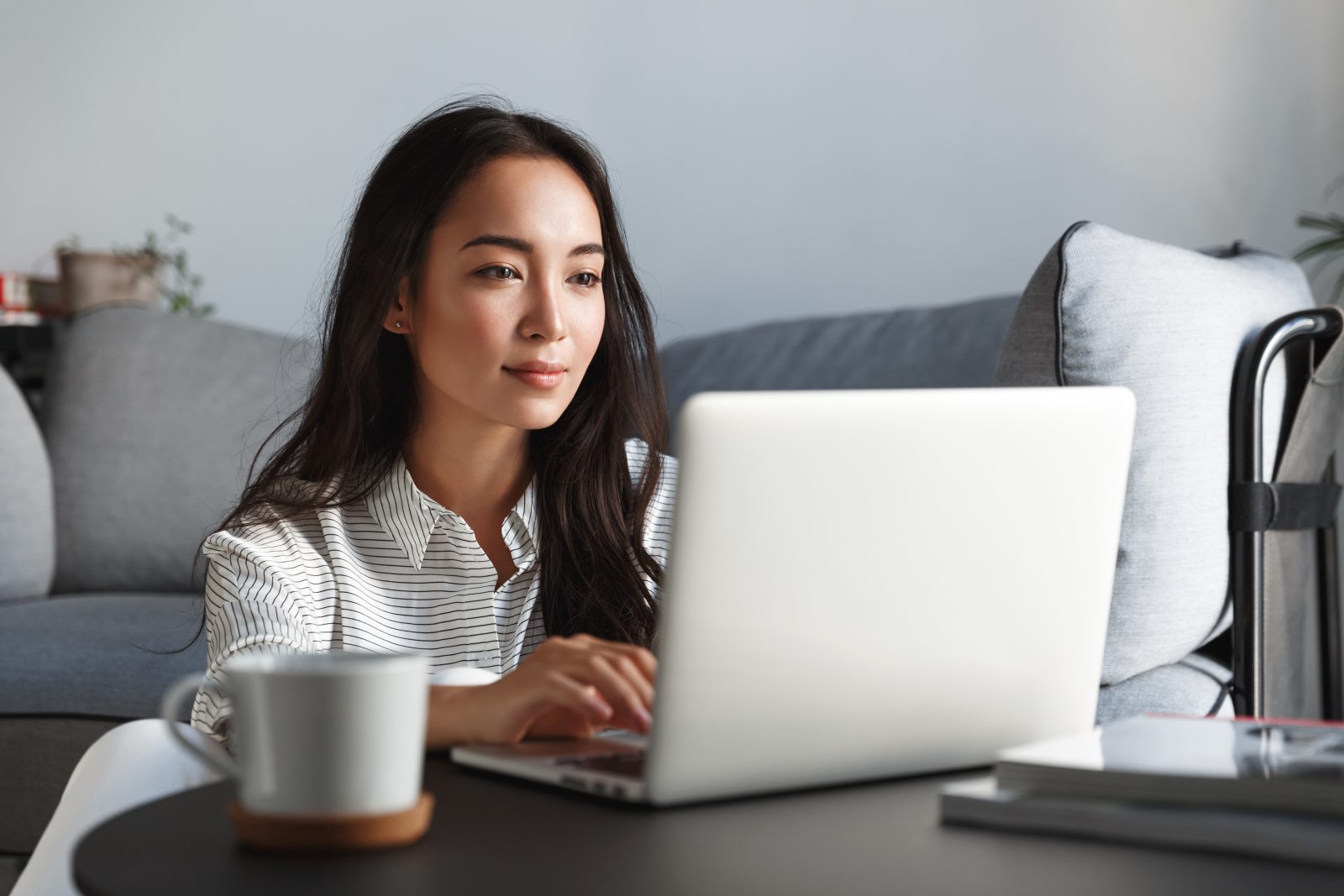 Woman laptop coffee couch